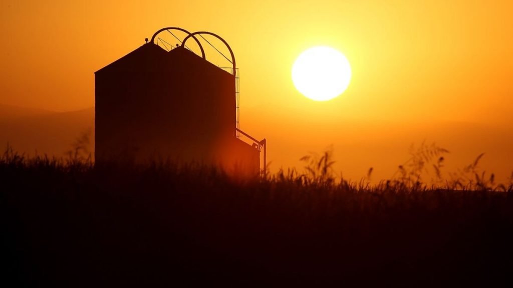 Grain Bin in front of a sunset